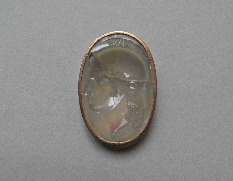 Intaglio; chalcedony; helmeted head of Roma to right; gem fractured across upper part; in metal mount.